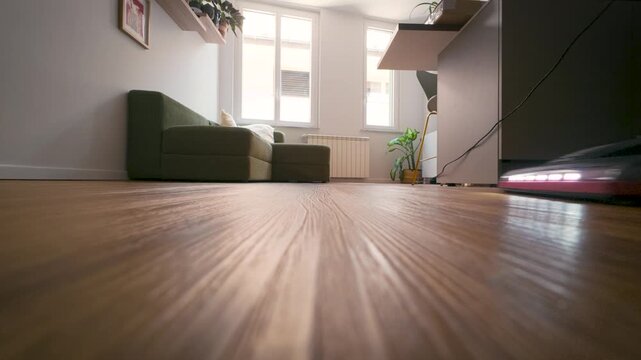 Vacuum cleaner close up on wooden floor, home cleaning, Italy