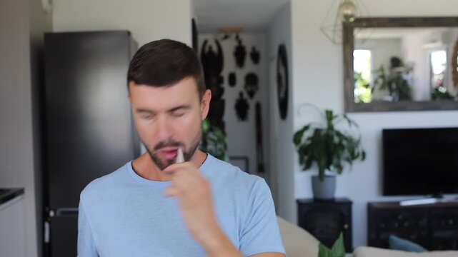 Handsome man brushing his teeth