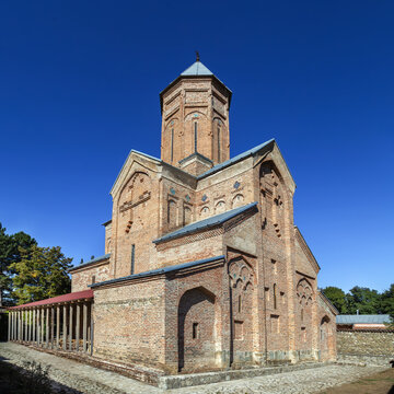 Akhali Shuamta Monastery church displays medieval brick architecture in Georgia. Front facade view in sunny daylight