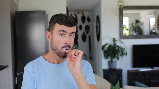 Handsome man brushing his teeth