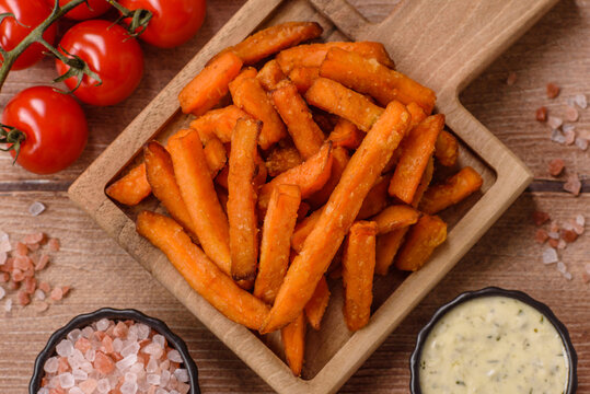 Seasoned sweet potato fries with sauce, fast food. Sweet potato fries