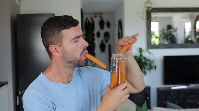 Man eating a bunch of sausages at once
