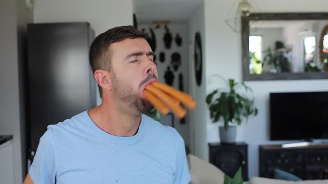 Comedic man eating a bunch of sausages at once
