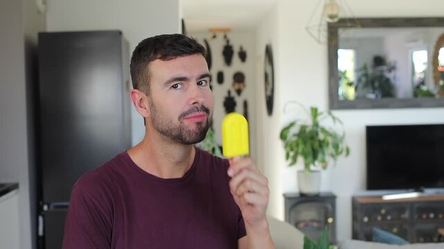 Handsome man eating a popsicle 
