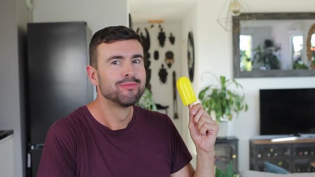 Handsome man eating a popsicle 
