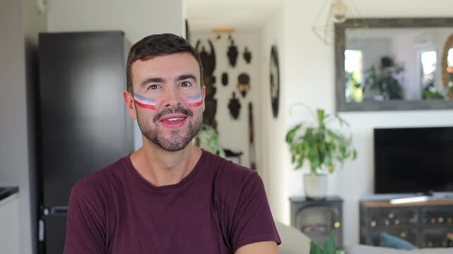 Man painting the french flag on his face