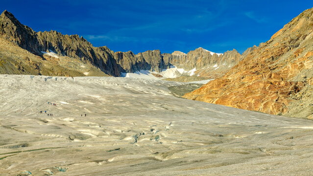 Rhonegletscher, Switzerland - 06.09.2025: Massive glacier with hikers on the surface