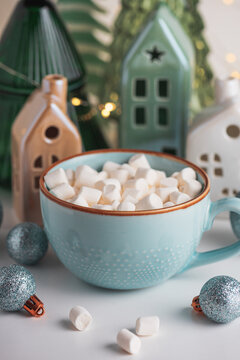 Hot chocolate mug with marshmallows welcoming winter holidays