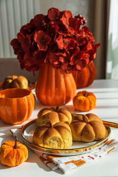 Pumpkin spice buns with autumn decorations and flowers