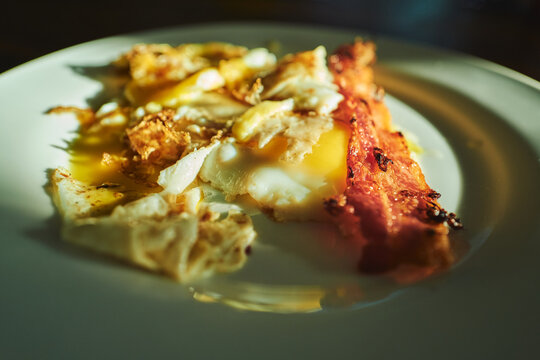 Bacon and fried eggs close-up in warm golden light