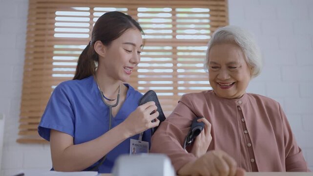 Health insurance with caregiver at home nurse senior blood pressure caregiver patient healthcare home woman stethoscope smile medical support consultation care visit bright room indoor check