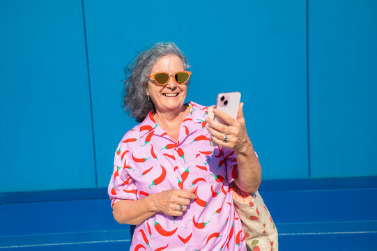 Elderly Woman Enjoying with Smartphone Outdoors
