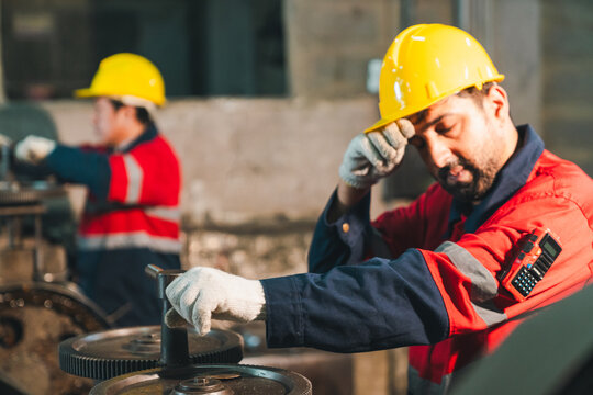 Construction worker hard hat safety glove industrial site factory uniform machine gear maintenance laborer sweating and working with equipment in workshop scene