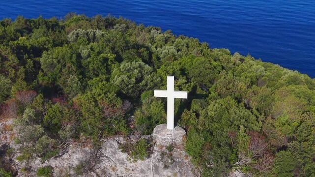 Aerial View of White Cross on Coastal Hill Above Arillas Bay, Epirus, Greece