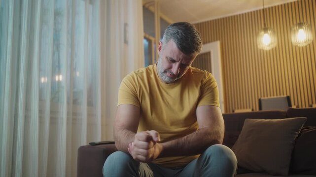 4k video, man arms massaging painful wrist after work on laptop computer at home, suffering from weakness and tingling, carpal tunnel syndrome, arthritis, neurological disease. Numbness of hand