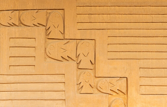 Adobe wall with fish decorations, Chan Chan archaeological site, Trujillo, Peru.