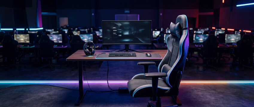 Empty professional gaming station with racing chair and desktop pc in esports arena