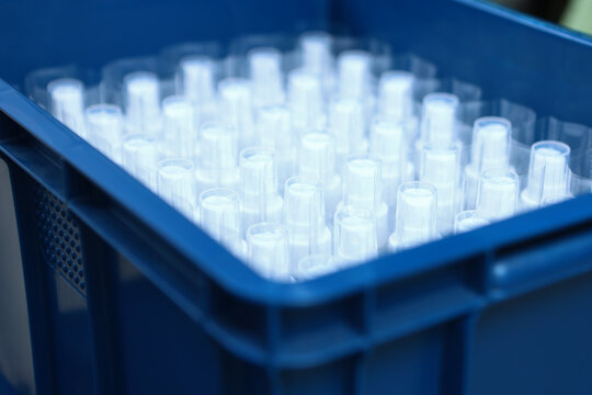 Large number of vials are in drawer. Production of cosmetics for skin care. Finished skin care products. Bottle has no label