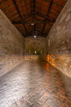 Ancient Romanesque chapel displaying stone walls and wooden roof