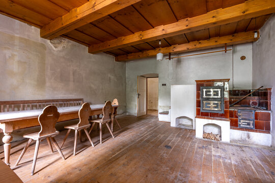 Traditional rustic room with wooden furniture and tiled stove