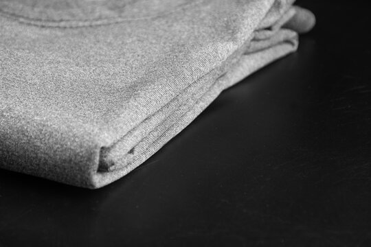 Folded heather gray T-shirt with a close-up of the dry-fit fabric at the fold.