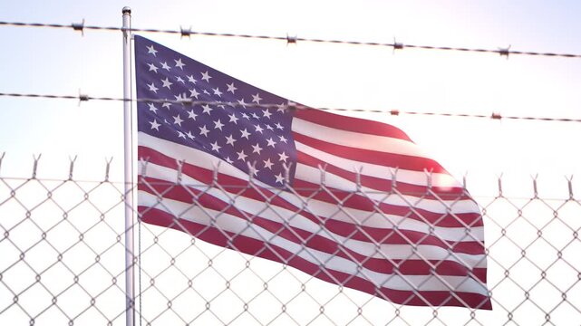 Flag of the USA United States behind barbed wire fence. Emigration and Immigration concept