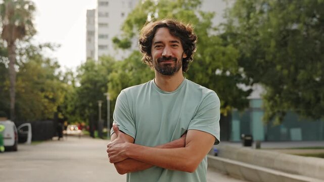 Portrait of young athlete Spanish man smiling looking camera in urban city 