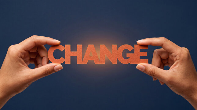 Hands holding orange paper letters spelling word change on blue.