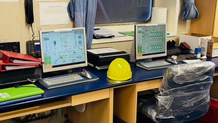 Ship officers desktop workstation with industrial automation diagnostics software on dual screens...