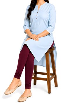 Woman Sitting on Wooden Stool Wearing Light Blue Kurta with Burgundy Leggings Isolated on White Background