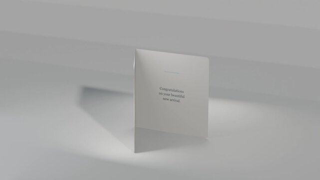 Tilting folded greeting card opening on pale surface, revealing congrats message with pastel stars