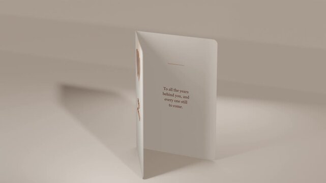 Opening card rotating and revealing copper hearts and anniversary message on beige studio at start
