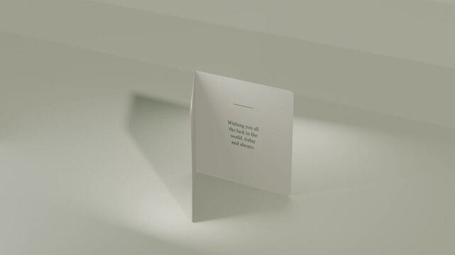 Camera rolling, card rotating and opening on studio table, revealing Good Luck clover, inside text
