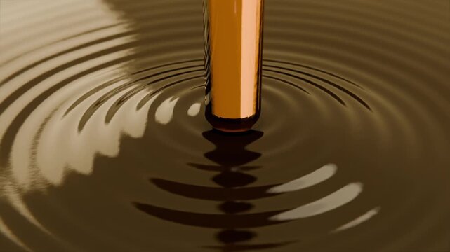 Lowering bronze rod touching brown liquid in studio pool, creating circular ripples with left glint