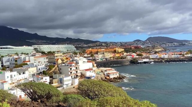 Costal top view on picturesque La Caleta village, popular travel destination, cloudy summer day in Costa Adeje, Tenerife, Canary Islands, Spain,4K.