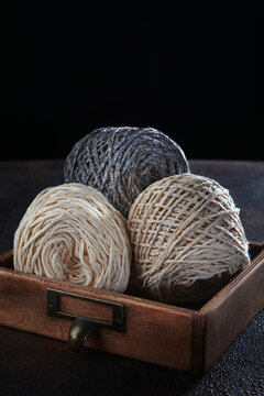 Wool tweed yarn for knitting in skeins is in wooden box. Yarn for knitting or crocheting. Handmade work. Hobby concept