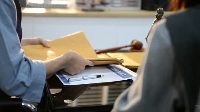 Close up of businessmen or lawyers discussing contract or business agreement at law firm office, Business people making deal document legal, justice advice service concept.