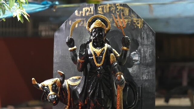 Lord Shani Dev Idol in Hindu Temple with Sacred Black Stone Background