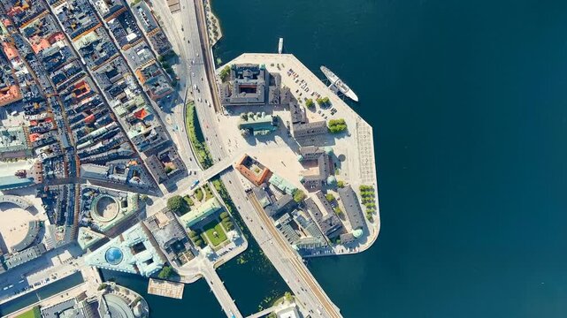Stockholm, Sweden. Riddarholmen island and its royal burial church, aerial top-down view over Lake Malaren with deep blue water and bright summer light. Drone footage, HEAD OVER SHOT with rotation