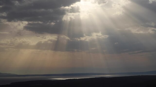 Sunrays above the sea. Rab island timelapse of passing rainstorms. Life on Croatian island in the Adriatic.