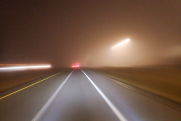 Night empty road highway with car lights blur in foggy misty weather © Midea 