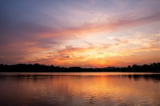 Tranquil sunset over calm lake with vivid sky reflections