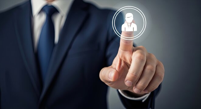 Professional Selection: A businessman in a sharp suit presses a glowing icon representing a person, symbolizing human resources, selection, or an online profile.