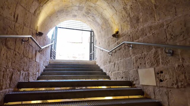 Walking Up Stone Stairs Through Iron Gate, Citadel, Victoria, Gozo, Malta A point-of-view shot walking up stone steps through an open iron gate within a stone archway inside the Citadel (Cittadella