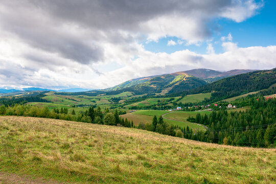 countryside meadow in mountain landscape of ukraine. lush grass fields at the foot of borzhava ridge. beautiful view of transcarpathian scenery in early autumn