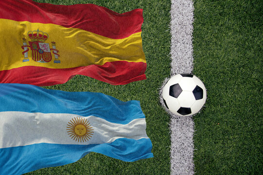 Soccer ball and the flag of Argentina and Spain