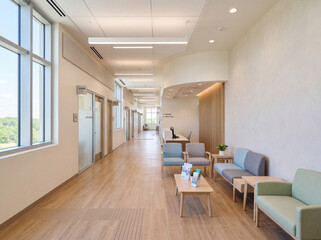 Fototapeta premium This space features a well-lit corridor in an oncology clinic with a comfortable waiting area. It has clean lines and simple furniture to support patients and their families