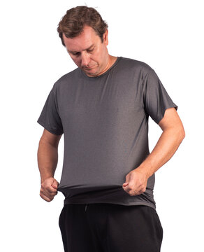 Male model wearing glasses and a short-sleeved, shiny, graphite-heather-gray polyamide sports shirt, stretching the fabric to demonstrate its elasticity.