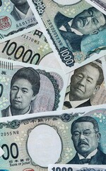 Japanese yen money bills in pile on table. Japan JPY currency cash close up © Viktor