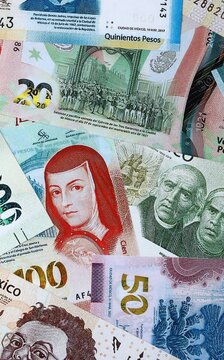 Mexican peso money bills in pile on table. Mexico MXN currency cash close up